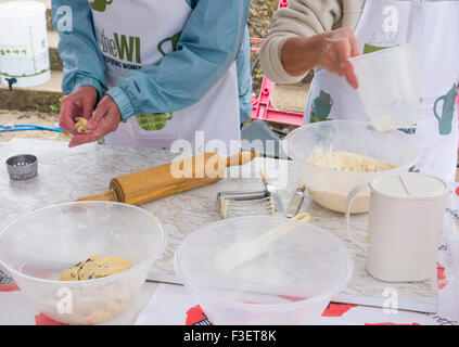 Women`s Institute members making cakes and scones on stall to sell with tea at Festival of Thrift. UK Stock Photo